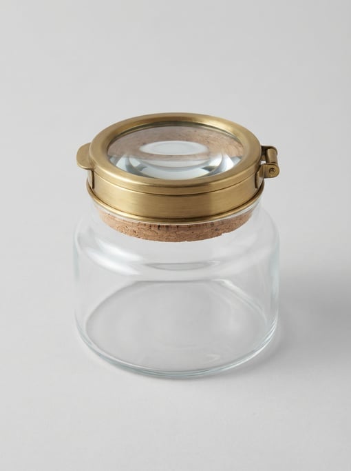 Brass magnifying specimen jar with a built-in glass lens lid, cork seal ring