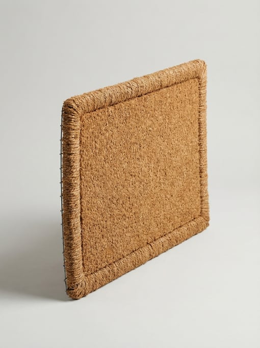 Natural coir doormat brush in coconut fiber with a rectangular shape, stitched border