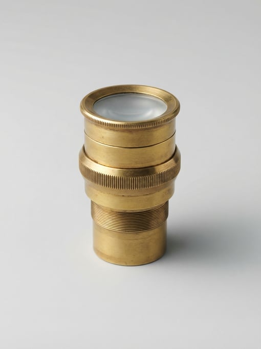 Antique brass telescope eyepiece in polished gold with a knurled focus ring, threaded barrel