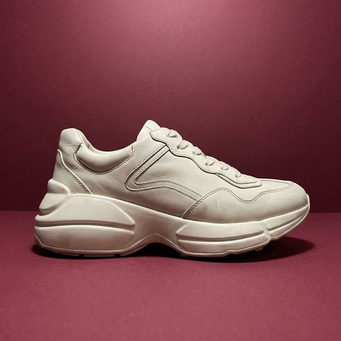 Chunky white leather sneaker with an exaggerated sole and tonal stitching