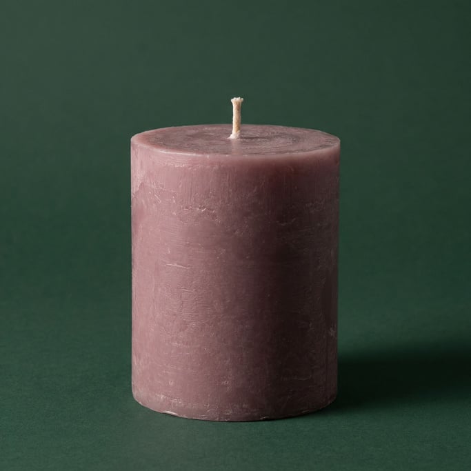 Soy wax pillar candle in dusty mauve with a cotton wick, soft two-point lighting