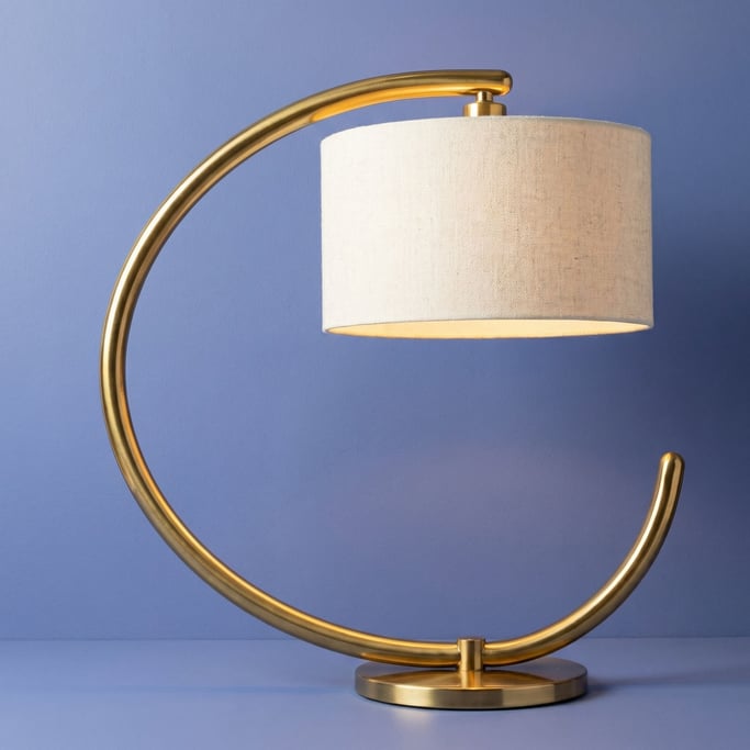 Mid-century brass arc desk lamp with a linen drum shade