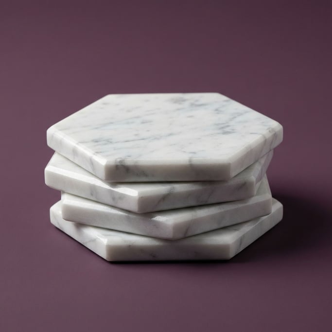 Set of four hexagonal marble coasters stacked neatly