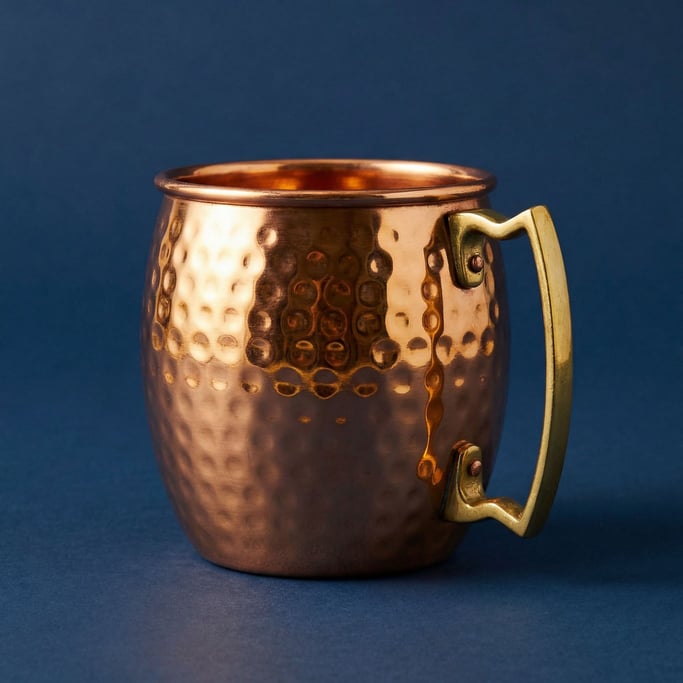 Copper Moscow mule mug with a hammered surface and brass handle