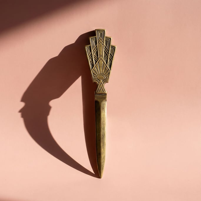 Brass letter opener with an art deco geometric handle