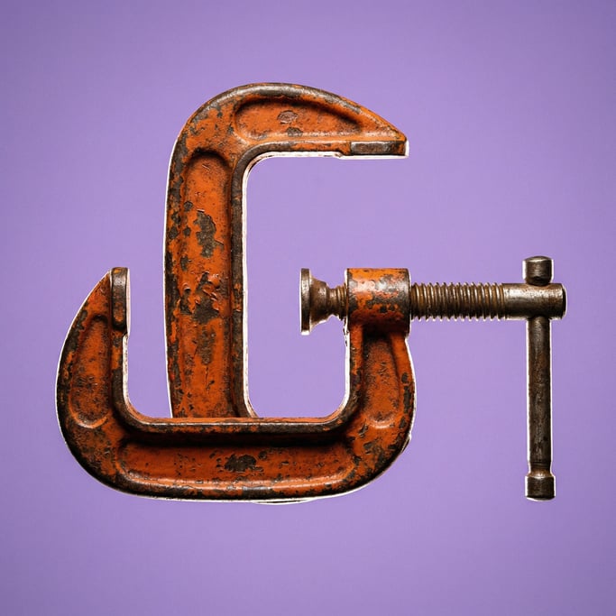Heavy-duty metal C-clamp with orange paint and a worn patina, rim light defining its profile