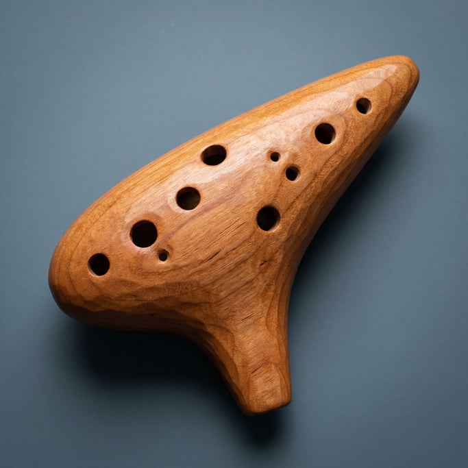 Wooden ocarina in warm cherry finish with eight finger holes