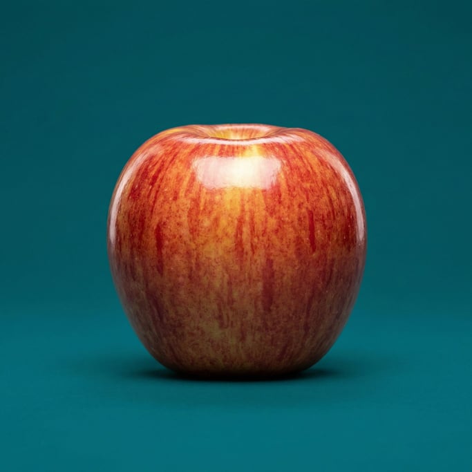 Single Fuji apple with a glossy red and yellow skin