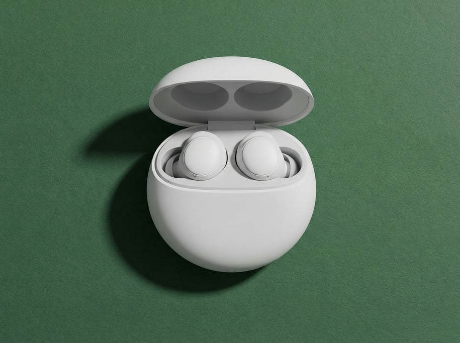 Noise-canceling sleep earbuds in their rounded white case