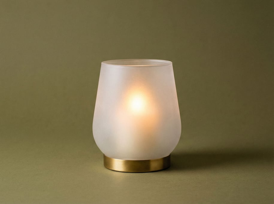 Frosted glass hurricane candle holder with a brass base ring