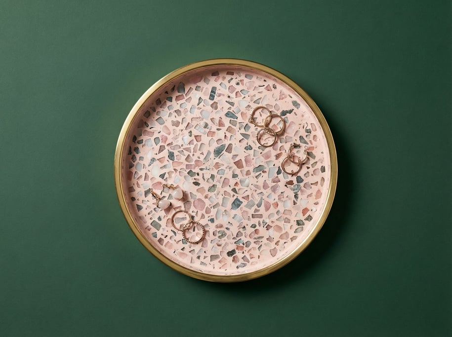 Terrazzo trinket tray in pink and grey chips with a polished brass rim