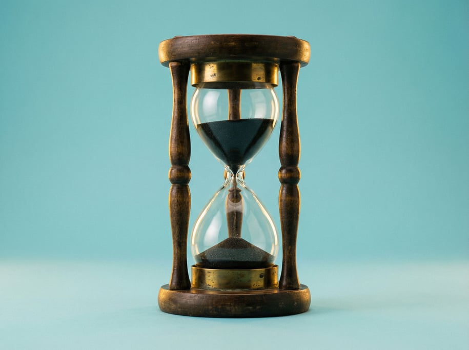Wooden hourglass timer with a brass collar and black sand