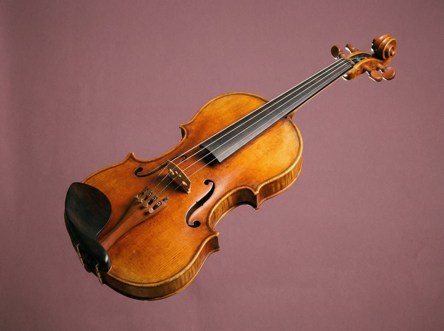 Classical violin in warm amber varnish with a chin rest and fine tuners visible