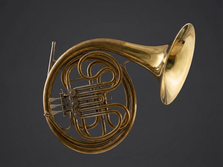 Brass French horn with a lacquered bell and rotary valves