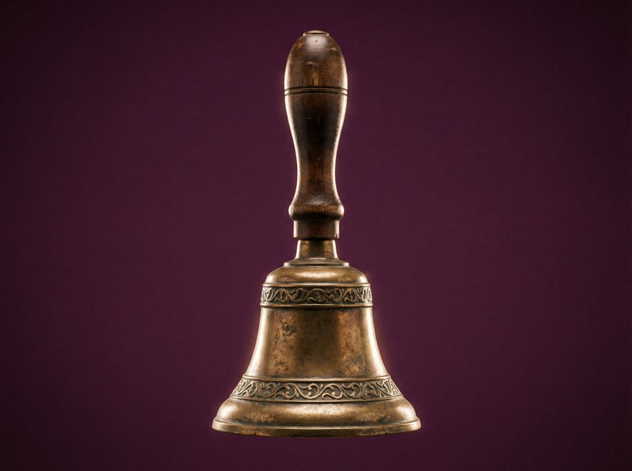 Antique brass bell with a turned wooden handle, studio rim light