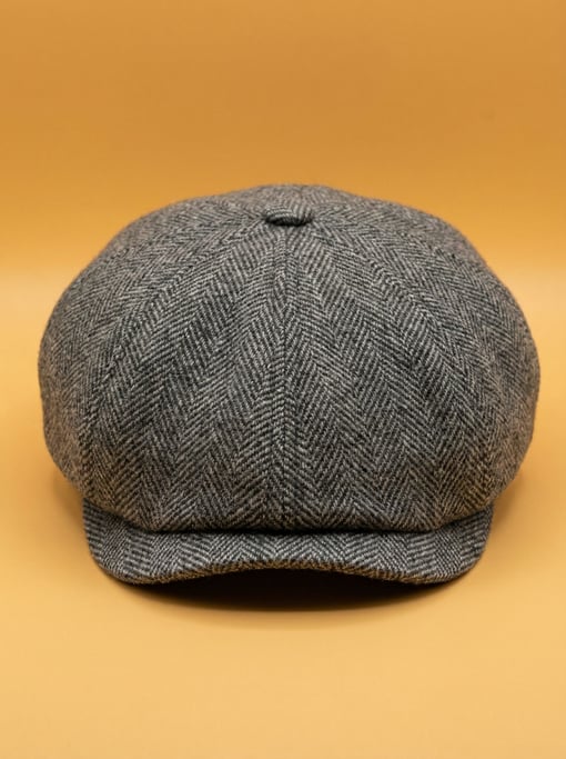Wool newsboy cap in herringbone tweed grey, soft studio fill light