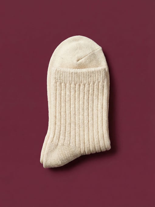 Ankle sock pair in thick ribbed cream cotton, folded and stacked