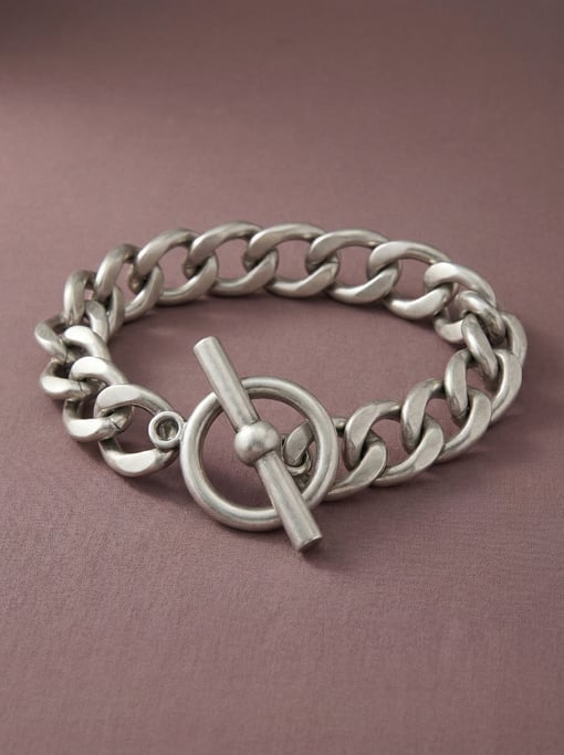 Chain-link waist belt in brushed silver with an oversized toggle clasp