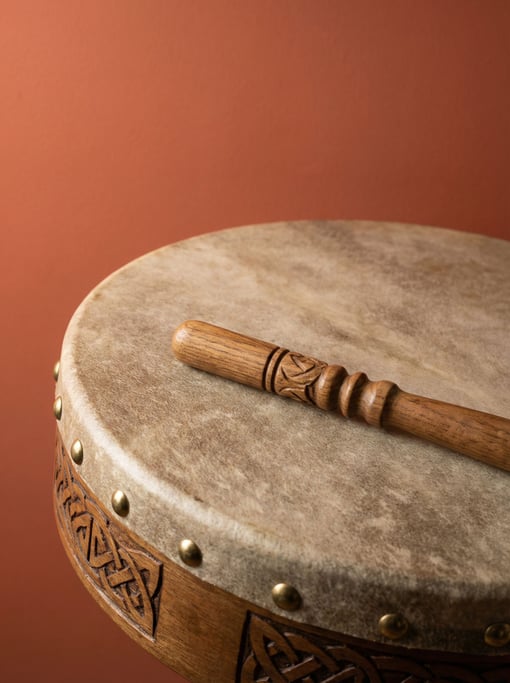 Celtic bodhran drum with a goatskin head and a tipper resting on top