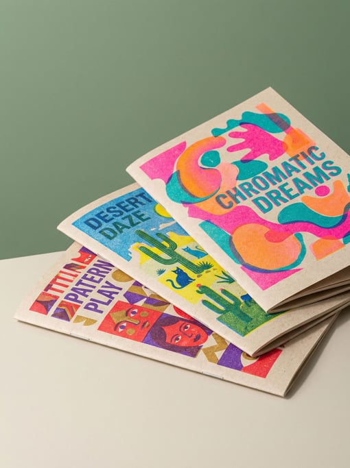 Stack of three art zines with colorful risograph covers, slightly fanned