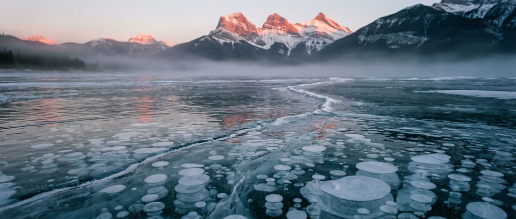 Frozen lake with methane bubbles trapped in layers of clear ice