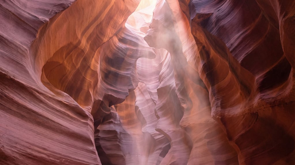A slot canyon with light beams penetrating from above