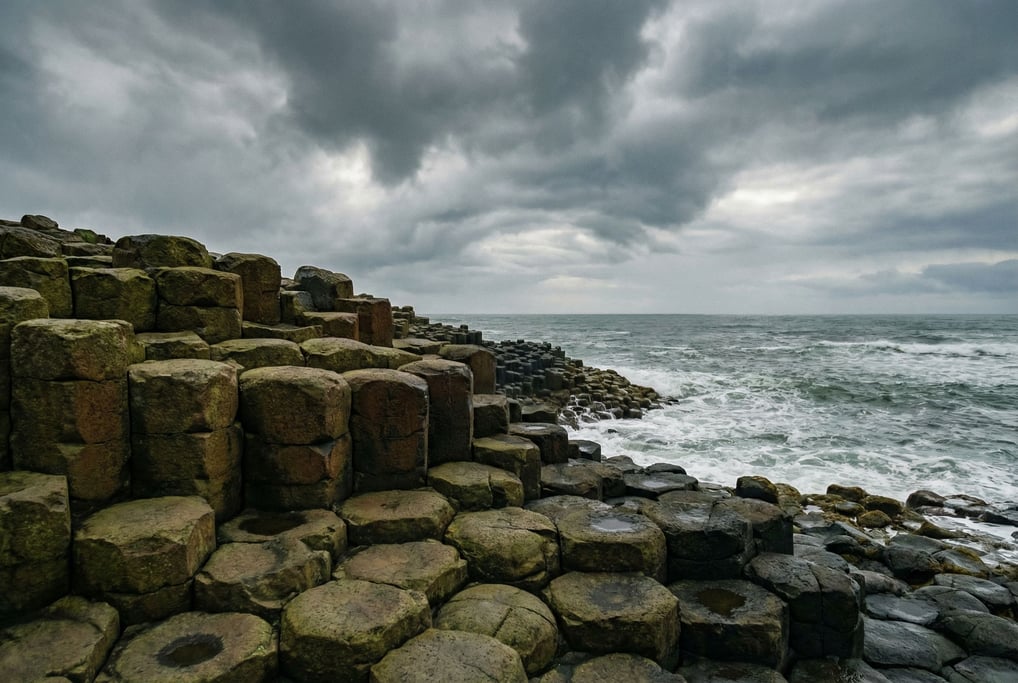 Giant hexagonal basalt columns at the edge of the sea, geometric natural forms worn smooth by waves (ohknkioa)