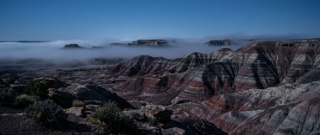 Painted desert hills in bands of red, purple, gray, and white (pmsfohx7)