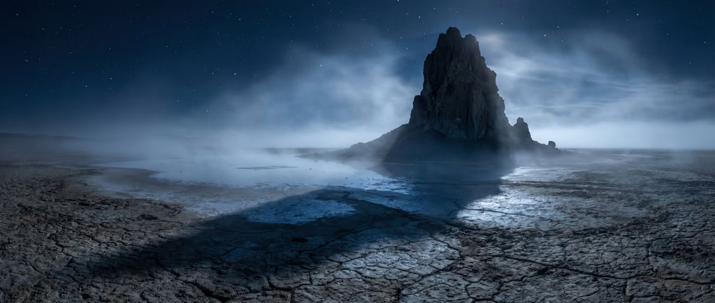 A volcanic plug rising alone from flat desert (x6aumrkp)