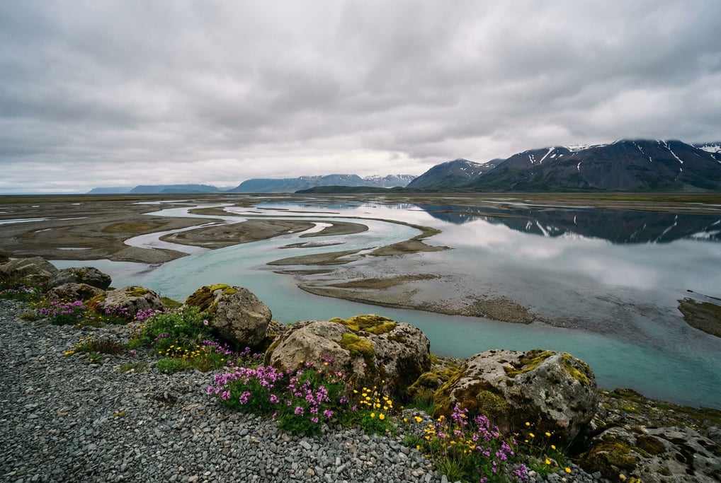 Turquoise glacial meltwater river braiding across a gray gravel plain, seen from above (cgfkxiys)