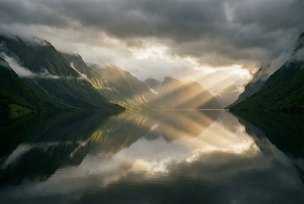 Fjord at dawn, dark mirror-still water stretching between steep green mountains disappearing into mi (sf1ehiv)