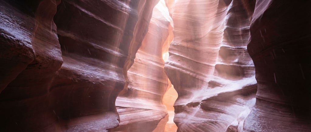 A slot canyon with light beams penetrating from above (buizaw5x)