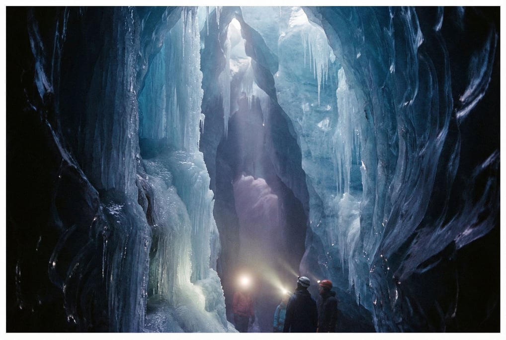 Ice cave interior, translucent blue walls with sunlight filtering through from above (fy4zy6m4)