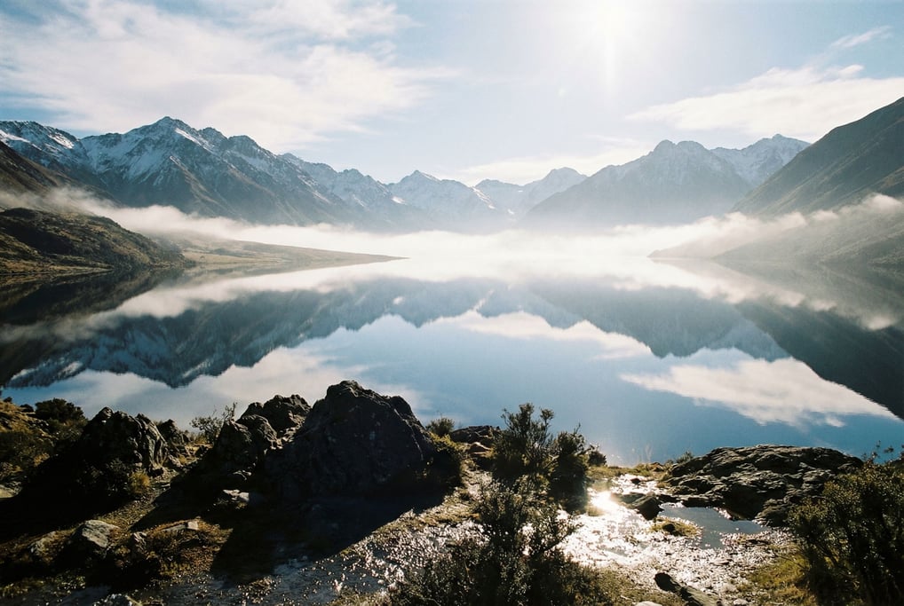 Mirror-perfect mountain lake reflecting snow-capped peaks (vknyko)