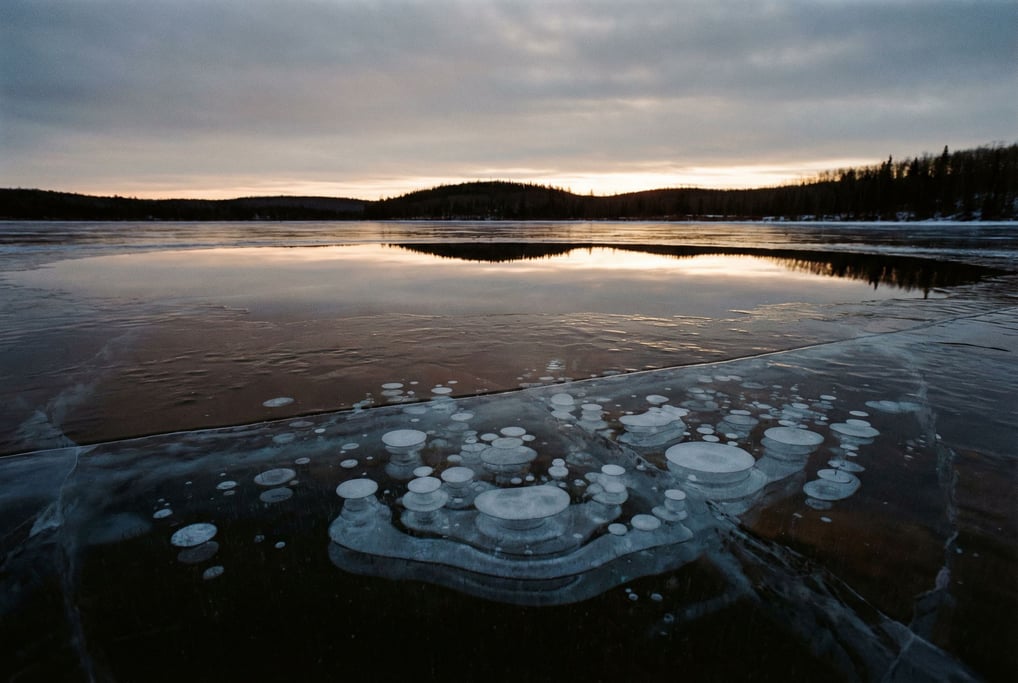 Frozen lake with methane bubbles trapped in layers of clear ice (vgib)
