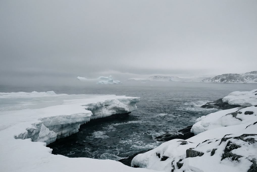 Frozen ocean shoreline, shelf ice meeting dark open water at a sharp boundary line (xcpr151t)