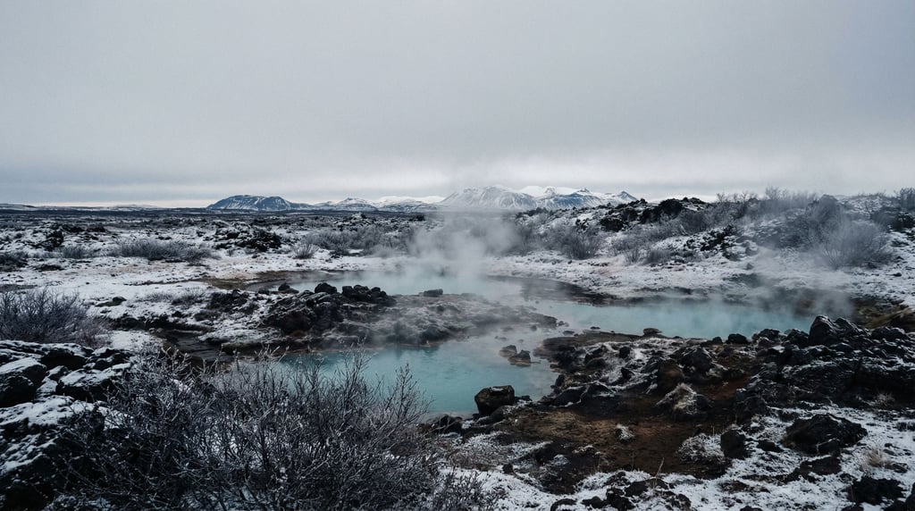 Snow-covered volcanic hot springs, steam rising from turquoise mineral pools into sub-zero air (qlbhtv9y)