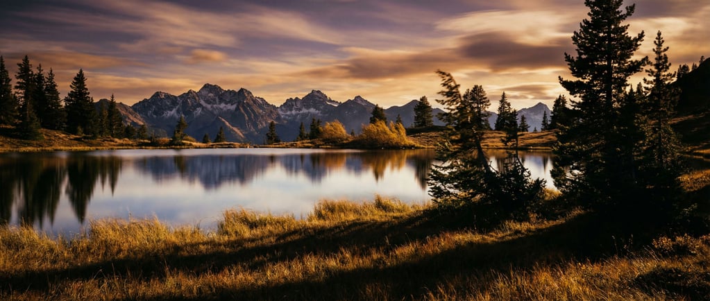 Mirror-perfect mountain lake reflecting snow-capped peaks (ly5vbwur)