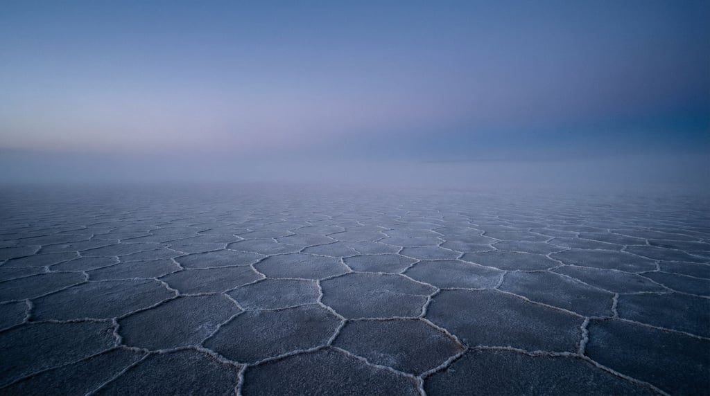 White salt flats stretching to the horizon, hexagonal crack patterns under a cloudless sky (3uiregr)
