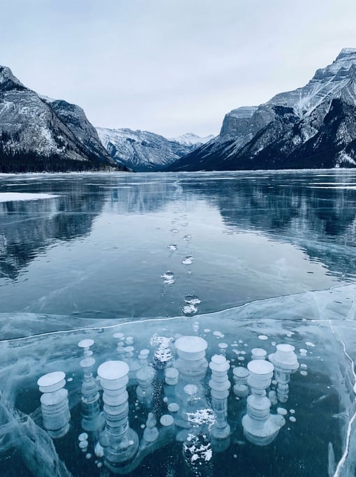 A frozen lake in the Canadian Rockies with methane bubbles trapped in layers of ice