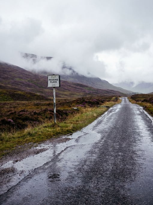 A rain-soaked mountain road in the Scottish Highlands