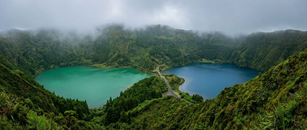 A dormant volcanic caldera in the Azores filled with two lakes of different colors — one green and one blue — separated by a narrow ridge