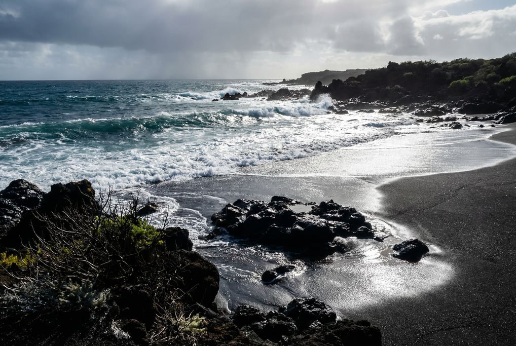 Volcanic black sand beach with turquoise waves breaking on shore, stark contrast of dark and bright (qc7aiacc)