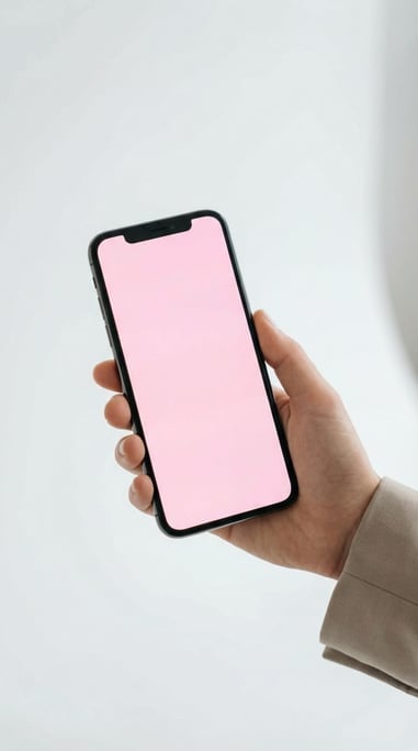 Hand holding a large-screen smartphone against a clean white studio background