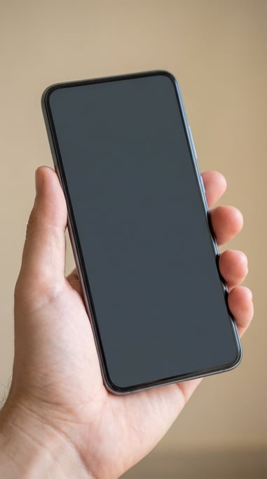 Hand holding a modern smartphone against a soft blurred beige background