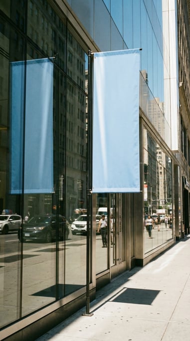 Tall vertical banner flag on a pole outside a glass storefront
