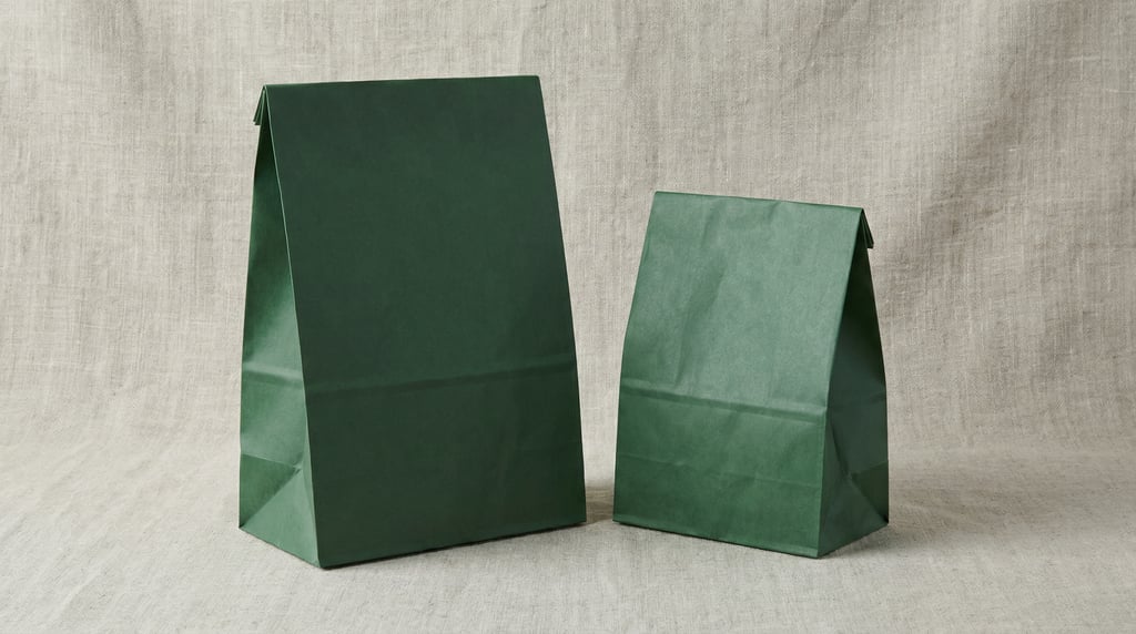 Paper lunch bag in matte forest green, two bags side by side different sizes