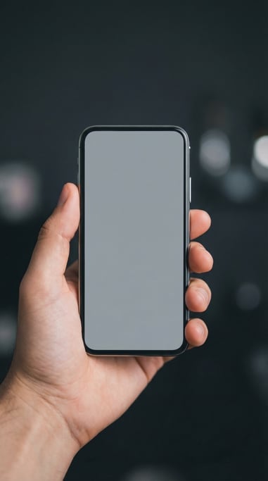 Hand holding a modern smartphone against a dark blurred background