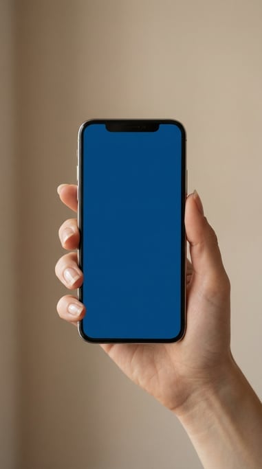 Hand holding a modern smartphone against a soft blurred beige background