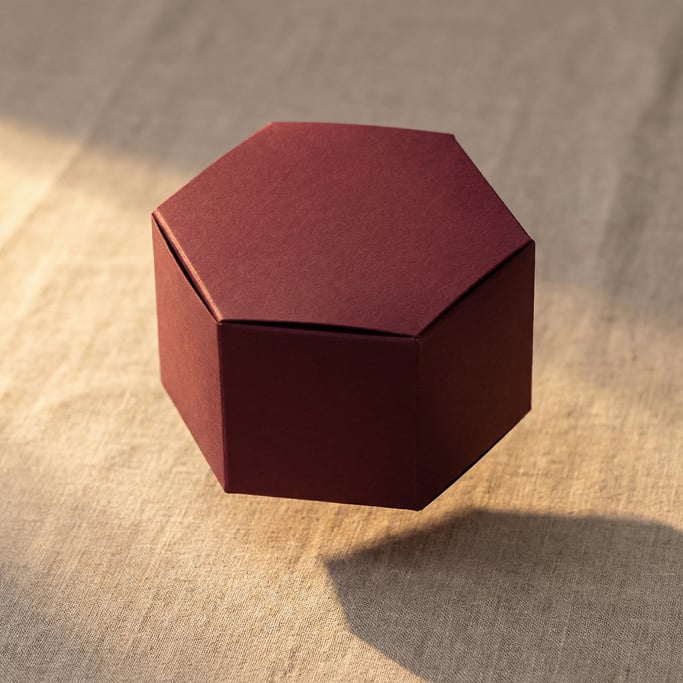 Hexagonal box, single box floating with shadow below, matte burgundy finish